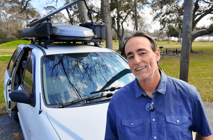 Ray standing in front of his minivan camper